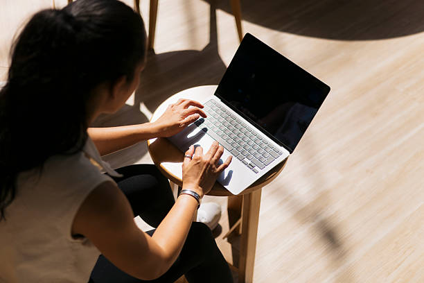 istock Young woman working on laptop in modern office space 2217157398
