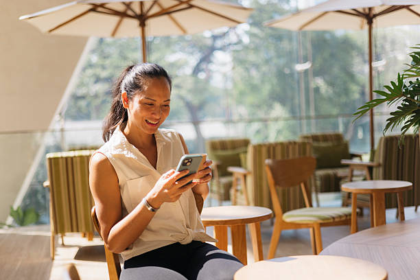 istock Businesswoman using smartphone in modern cafe, enjoying break time 2217157571