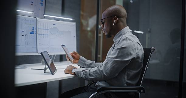istock Financial Analyst Analyzing Exchange Market Charts on Digital Tablet, Smartphone and Computer 2217158067