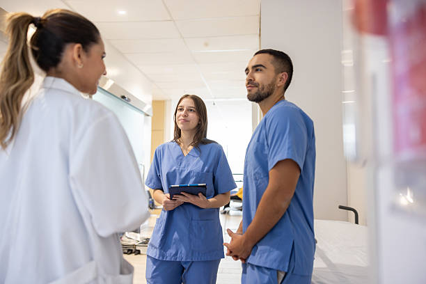 istock Doctor talking to two nurses at the hospital 2217159689