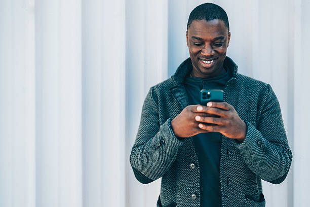 istock African-american man texting on phone 2217160802