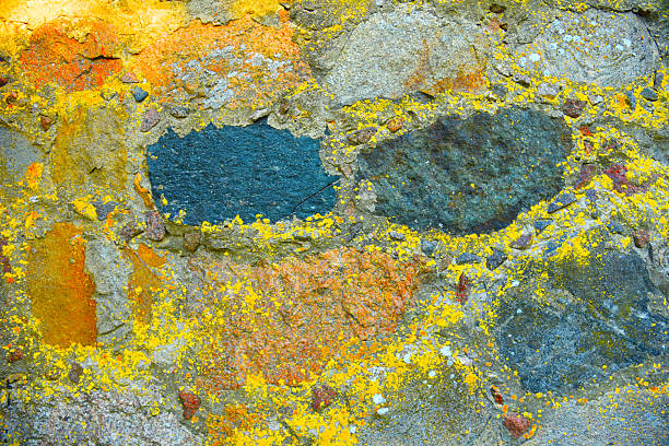 Stone wall. Background of old stone wall with concrete. Old stones in concrete structure. Concrete wall texture. Sidewalk background, texture. Stone paving sidewalk. Pedestrian paving for footpath.