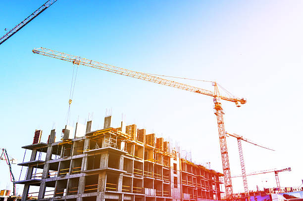 istock Tower crane on building construction on blue sky. Formworks, Pouring concrete on construction site. 2217171784