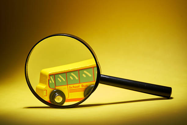 Magnifying glass focus on a toy school bus