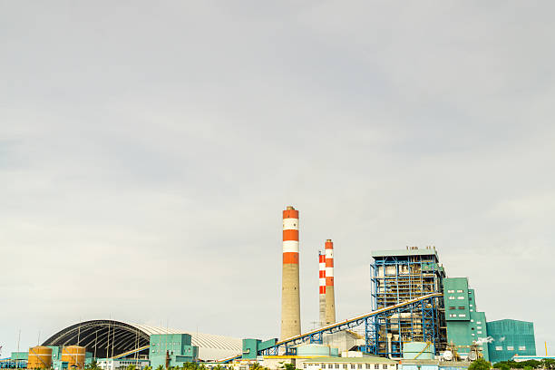 istock coal fired steam power plant complex with red-and-white striped chimneys. 2217177406