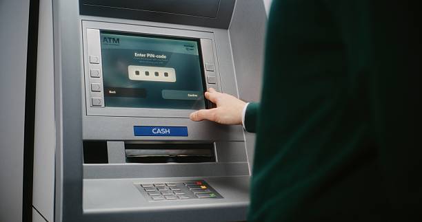 istock ATM User Entering PIN Code on ATM Keypad. Error Message on Cash Machine Screen Due to Blocked Card 2217179359