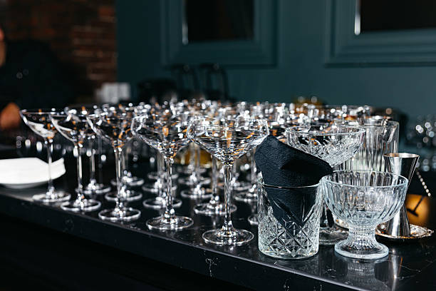 istock Clean cocktail glasses arranged on bar counter. 2217179373