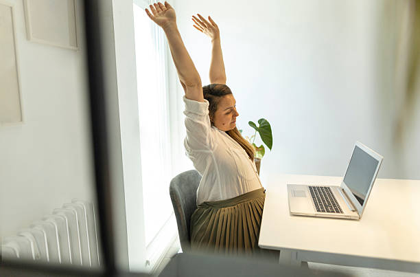 istock Photo from the side, expectant mother working at her home office 2217180577