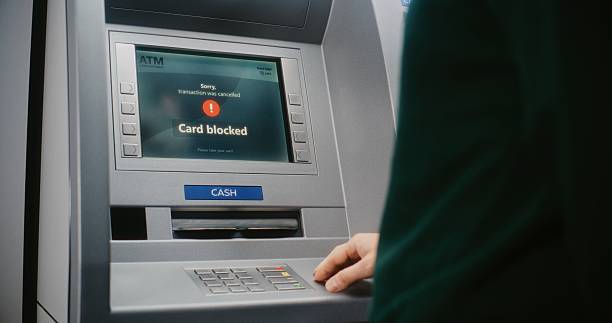 istock ATM User Entering PIN Code on ATM Keypad. Error Message on Cash Machine Screen Due to Blocked Card 2217180959