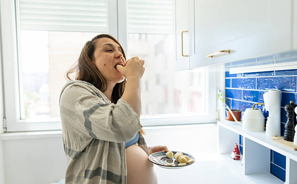 istock Expectant mother enjoy during eating bananas 2217181093