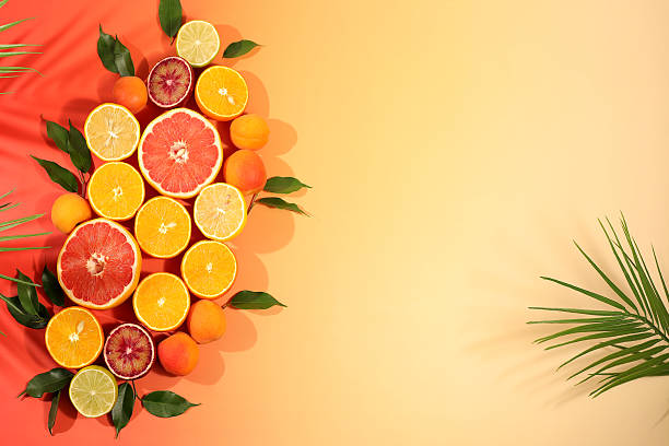 istock Fruity sunny banner. Summer in a snapshot, oranges, apricots, lemons, grapefruit on a bright background with shadows from a palm tree, Tropical background with exotic fruits, template for your design 2217181150