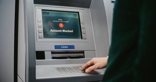 istock ATM User Entering PIN Code on ATM Keypad. Cancelled Transaction Due to Blocked Bank Account 2217181587