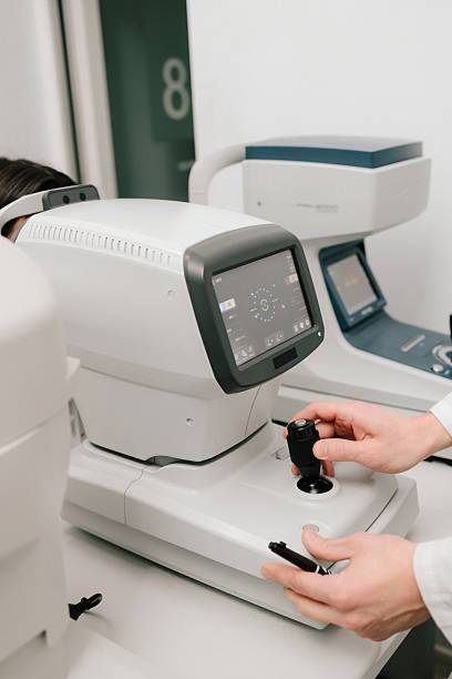 istock Autorefractor provides precise measurements for vision correction and eye health assessment. A close-up of an optometrist adjusting an autorefractor during an eye exam. 2217181965