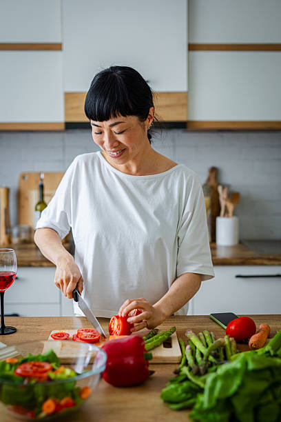 istock Woman in kitchen cooking healthy meal 2217183936
