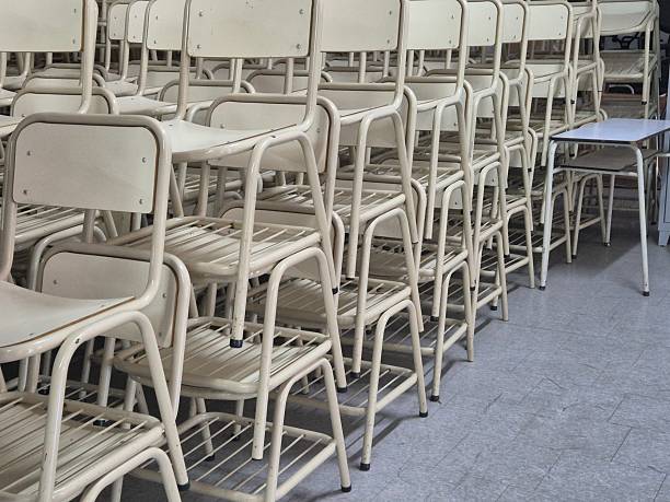 school desks stacked in a shed