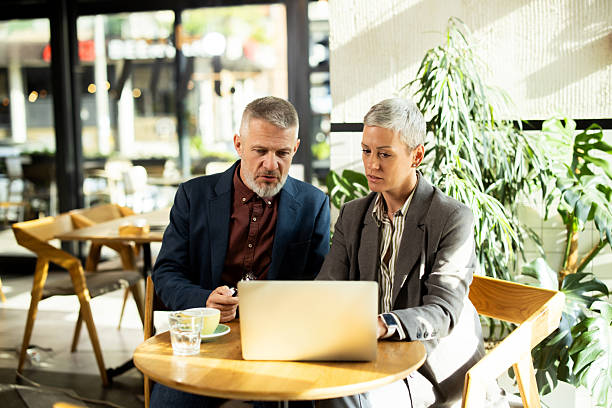 istock Business people working on laptop in cafe 2217186542