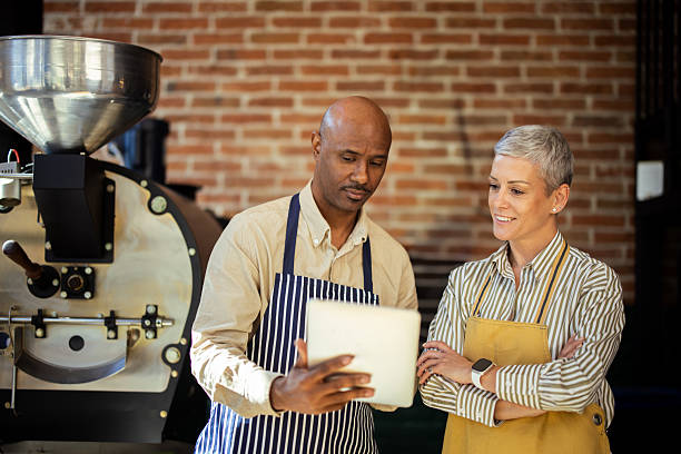 istock Coffee shop owners using digital tablet and discussing business strategy 2217186711