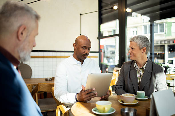 istock Business people having a meeting at a cafe using digital tablet 2217187481