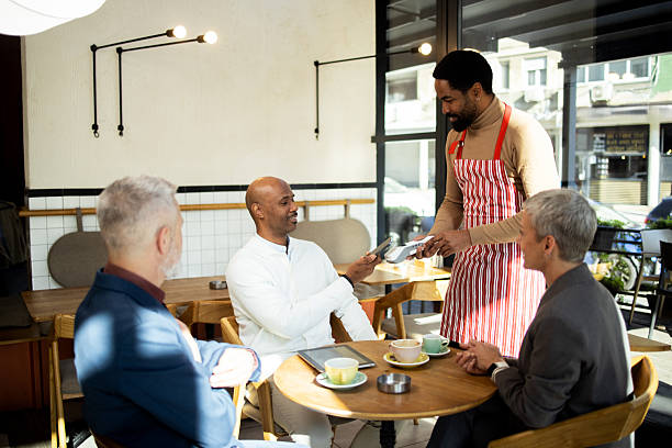 istock Customers paying with contactless technology in cozy coffee shop 2217187543