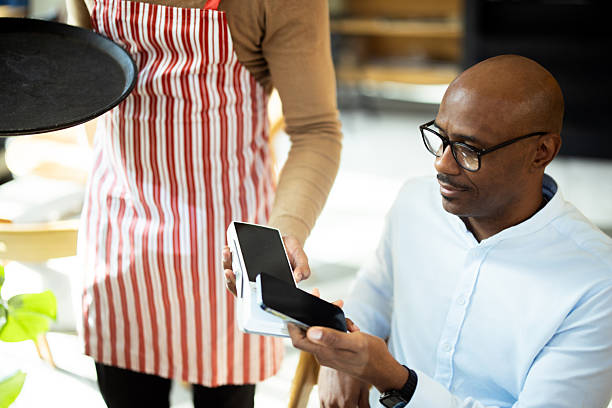 istock Customer paying with contactless payment in restaurant 2217187627