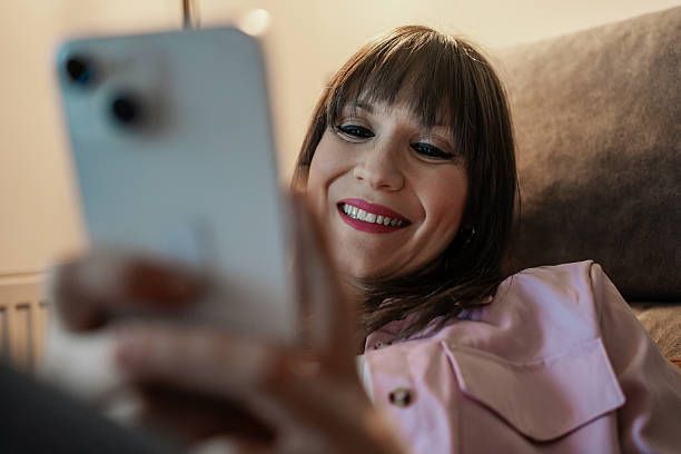 istock Woman relaxing on sofa, using smartphone and enjoying social media 2217189406