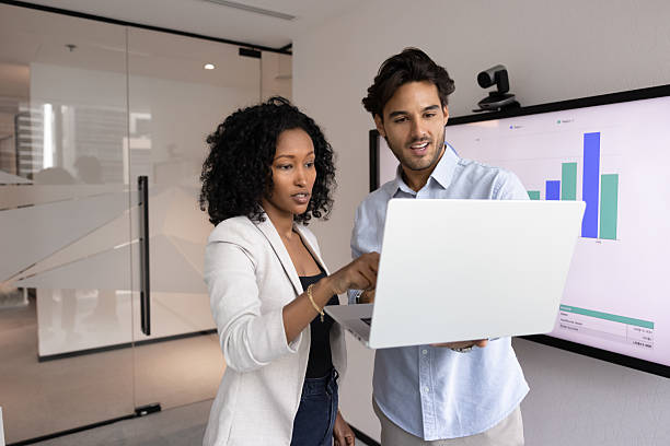 istock Hispanic and African teammates using modern laptop in office 2217189873