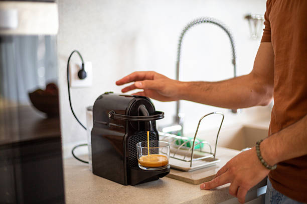 istock Man preparing espresso coffee with coffee machine in kitchen 2217191296