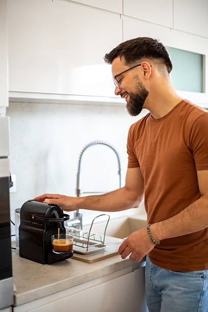istock Young man preparing espresso coffee at home in the kitchen 2217191337