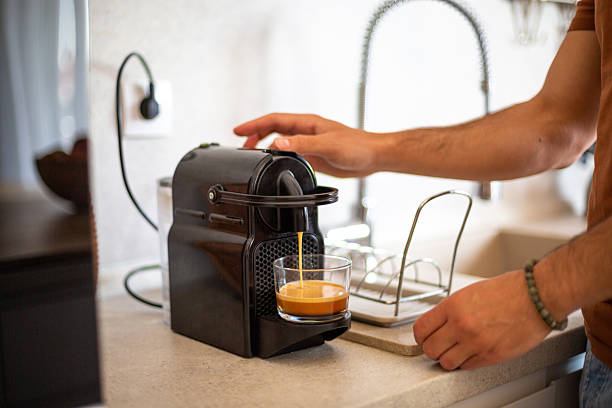 istock Man preparing espresso coffee with machine in kitchen 2217191350