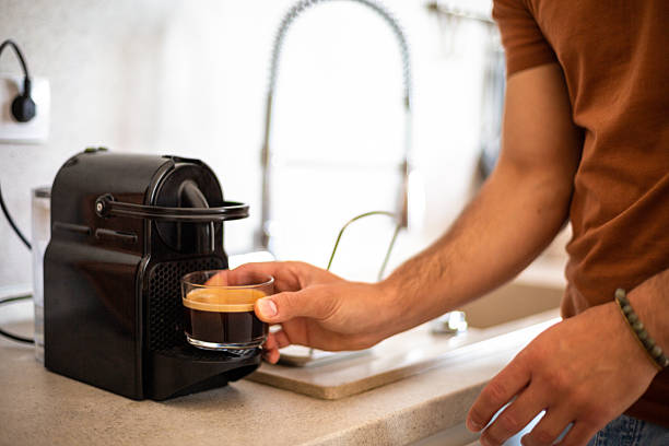 istock Man making espresso coffee at home in modern kitchen 2217191352