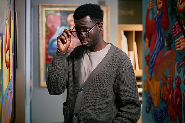 istock Adjusting Glasses in Vibrant Art Gallery Setting 2217192288