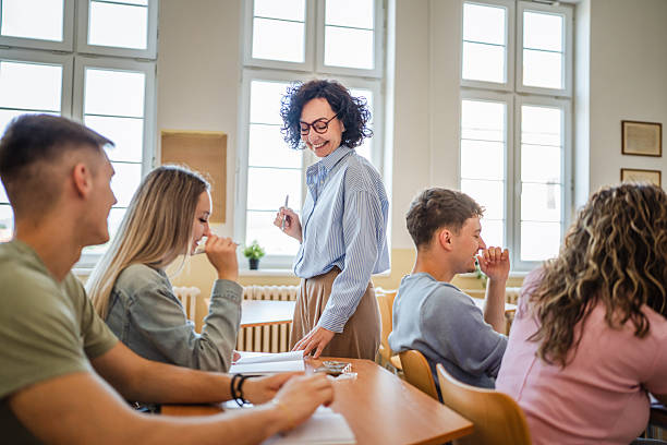 istock Female teacher help high school students do exercises in classroom 2217195037