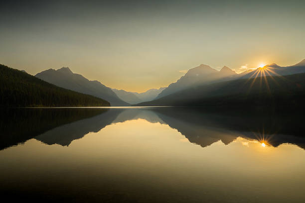 istock Warm Sunburst Starts The Day Over Bowman Lake In Glacier 2217196192