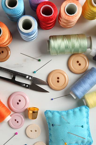 istock Different sewing supplies on white marble table, flat lay 2217198534