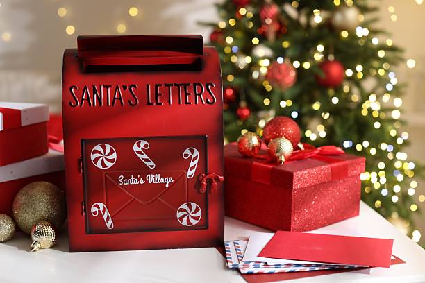 istock Santa Claus mailbox, letters, gift boxes and Christmas decor on white table indoors 2217198560