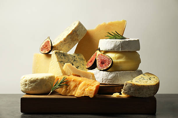 istock Different types of cheese, figs and rosemary on grey table 2217198629