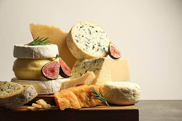 istock Different types of cheese, rosemary and figs on grey table, closeup. Space for text 2217198638