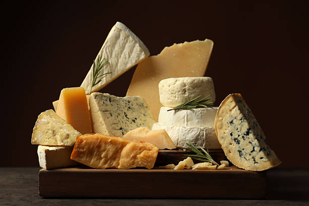 istock Different types of cheese and rosemary on grey table 2217198645