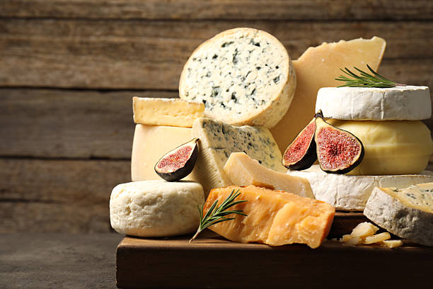 istock Different types of cheese, figs and rosemary on grey table, closeup. Space for text 2217198647