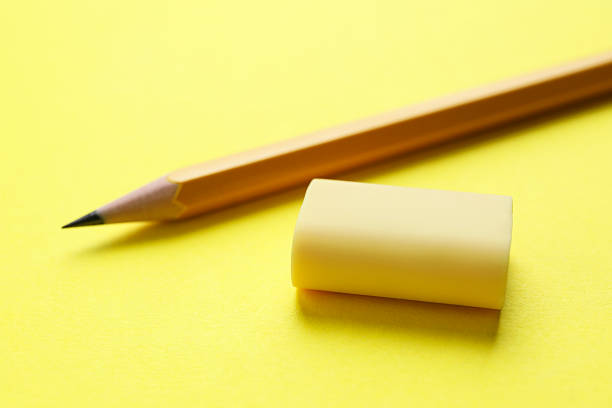 Yellow pencil eraser remove black line pencil on paper background copy space