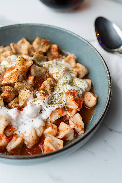 Turkish dumplings with yogurt and tomato sauce