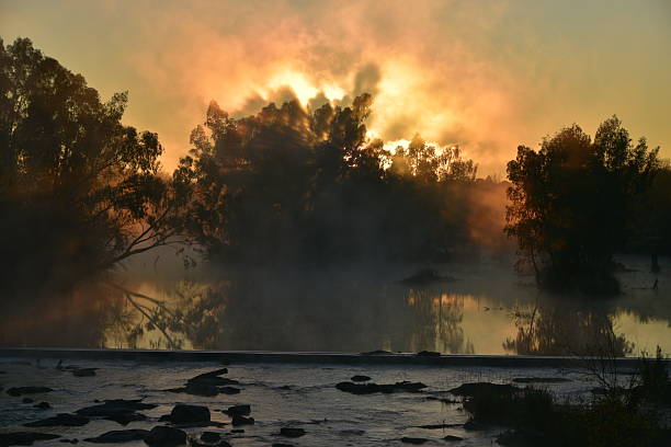 istock Tranquil Sunrise Over a calm South african River with Reflective Waters and Trees 2217207365