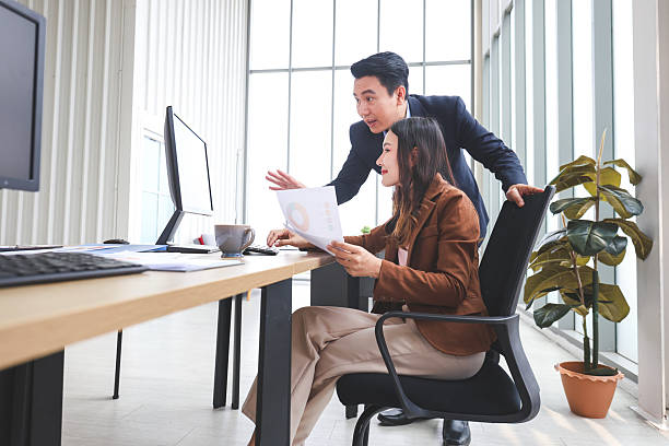 istock Supervisor training and suggesting about work to colleagues, Man and woman discussing ideas and meeting in office, Business people discussing documents in office 2217207747