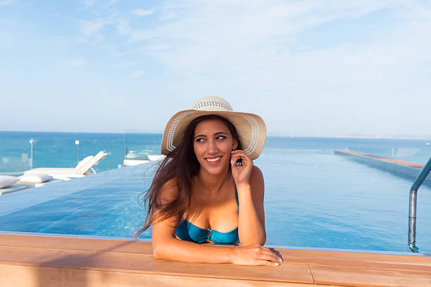 istock Young woman spending time at the swimming pool 2217208899