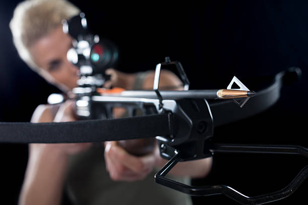 Young woman bow hunting with crossbow