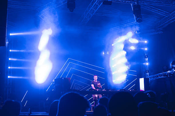 istock Dj playing techno music on the stage in summer 2217210318
