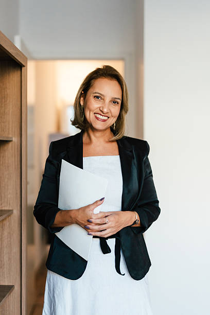istock Woman with arms crossed holding notebook 2217210528