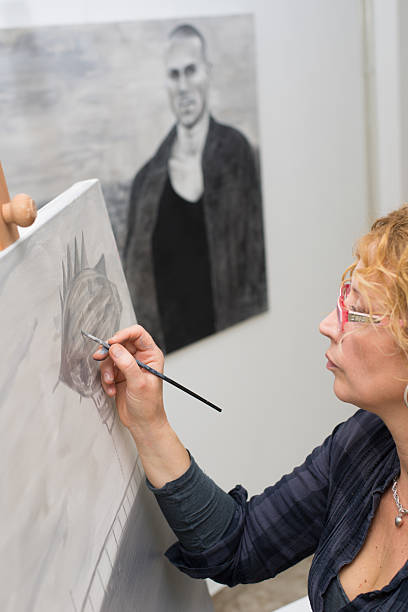 istock Female painter painting in her studio 2217211059