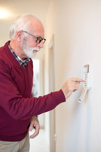 istock Senior man setting up home alarm 2217211620