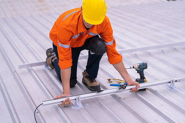 istock Technician in safety uniform and helmet kneeling on a rooftop, using a drill for precise installation work. A scene highlighting safety, professionalism, and technical expertise in construction. 2217212121